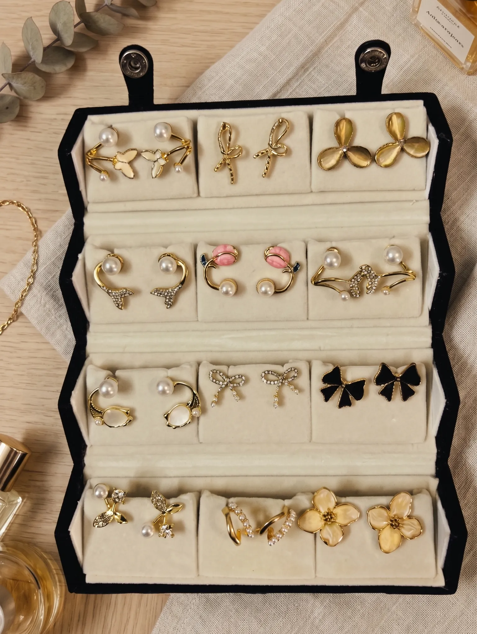 12-Pair Curated Korean Fashion Earring Gift Set 5 Curated 12-pair gold and pearl fashion earring collection displayed in an open black velvet four-tier jewelry travel organizer roll