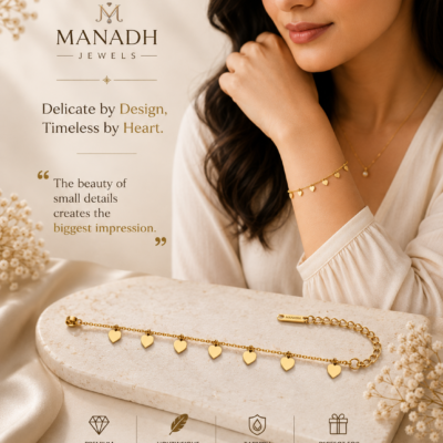 Gold heart charm bracelet by Manadh Jewels featuring multiple polished heart pendants on an adjustable stainless steel chain with a premium gold finish, displayed on an elegant marble backdrop.