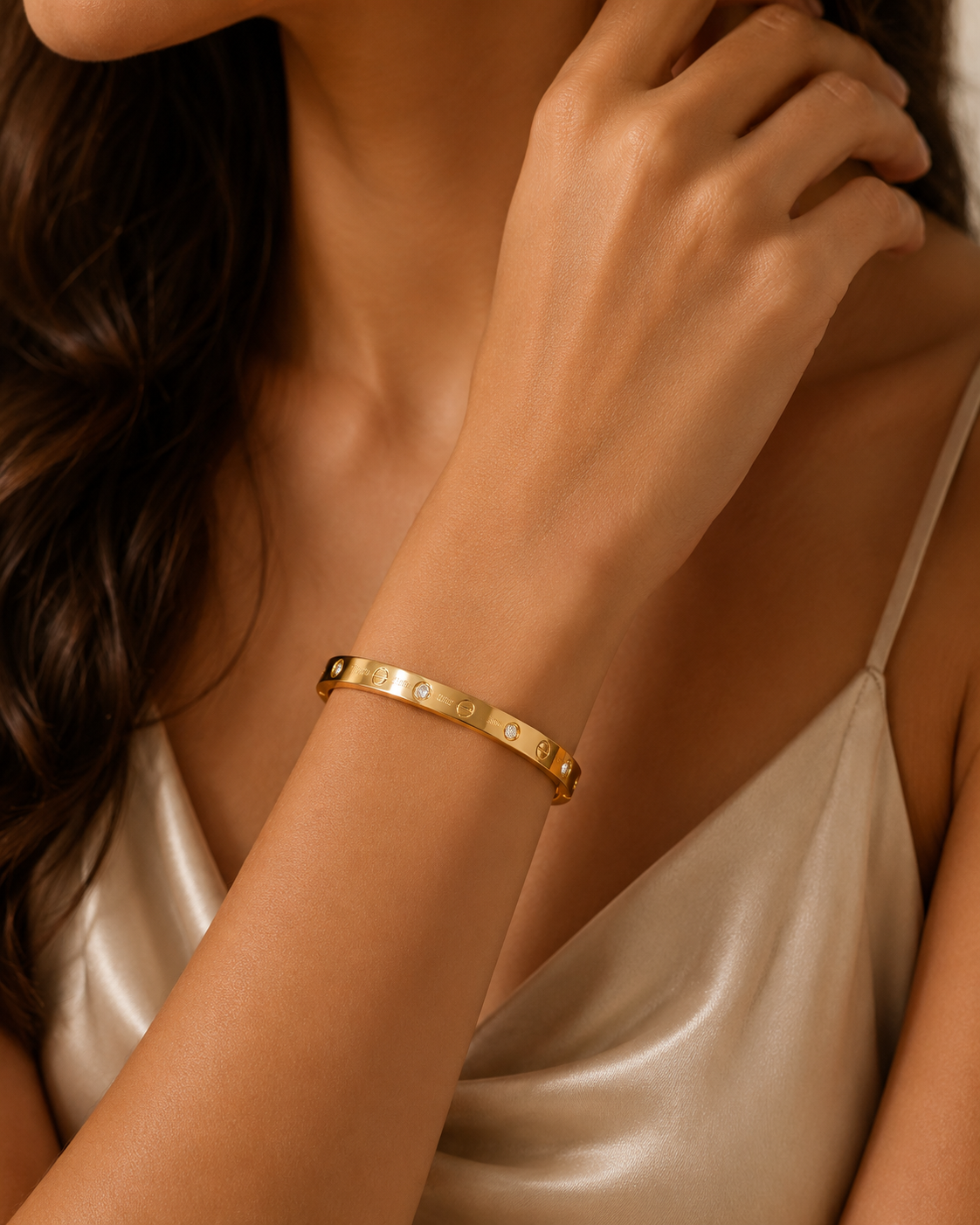 Gold Tone Crystal Accent Bangle MND-BR005 Slide3 Gold-tone polished bangle with circular detailing and sparkling crystal accents