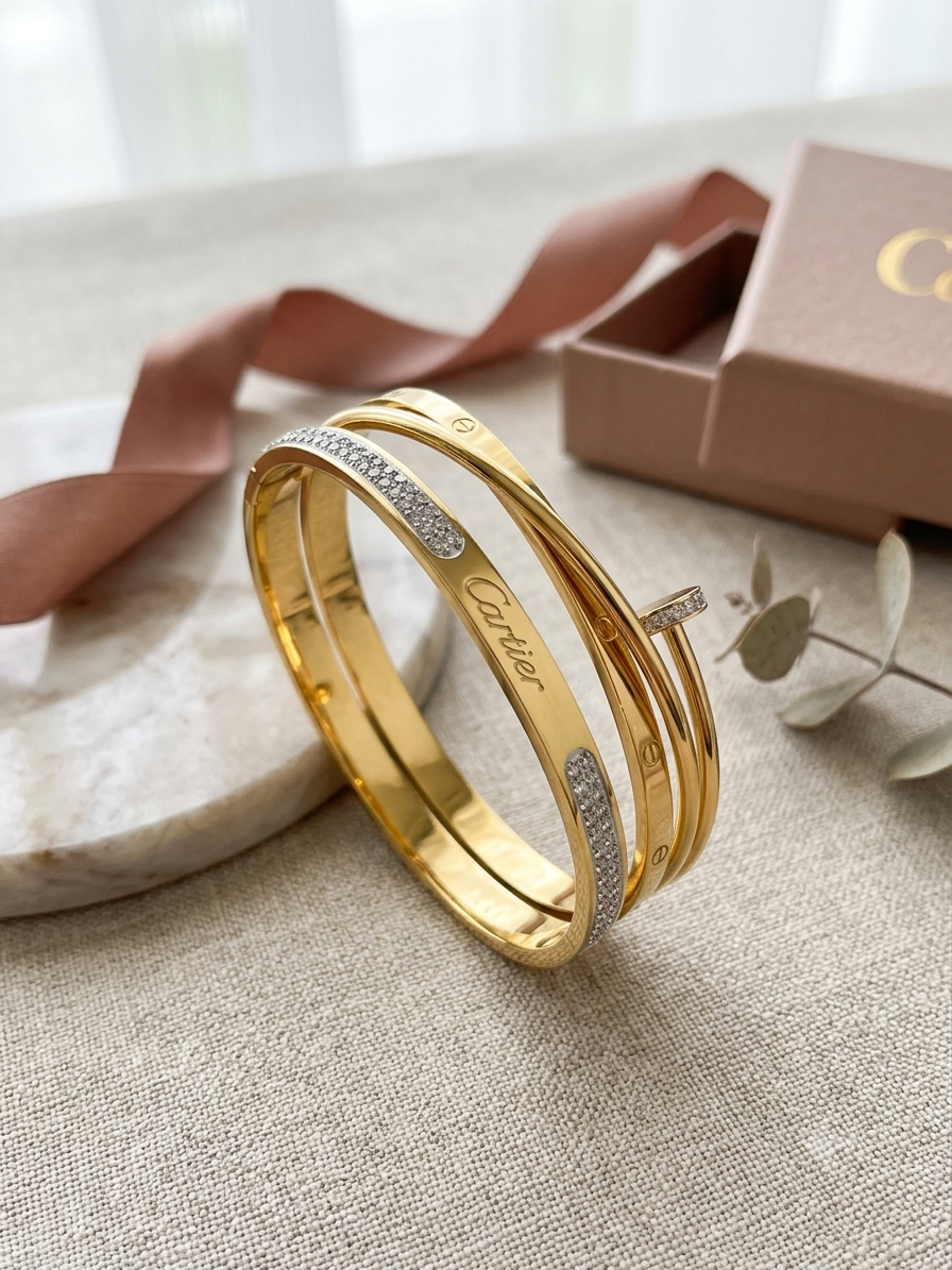 Gold-Tone Statement Bangle MND-BR001 Slide1 Gold-tone layered statement bangle with sparkling accent detailing on a wooden luxury jewellery display