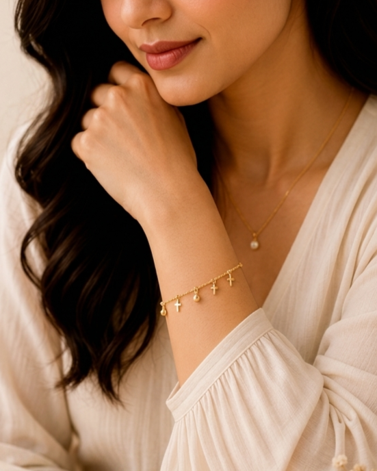 Holy Cross Charm Gold Bracelet MND-BR008 Slide3 Manadh Jewels Cross Charm Gold Bracelet featuring minimalist gold cross charms, polished bead accents, adjustable stainless steel chain, and elegant tarnish-resistant finish on a luxury marble background.