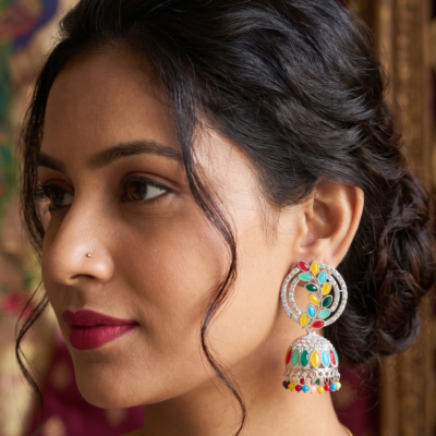 Premium multicolor oxidized jhumka earrings featuring colorful stone embellishments, intricate silver detailing, and decorative hanging beads displayed by Manadh Jewels
