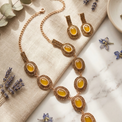 MANADH JEWELS yellow stone necklace set with matching earrings in gold-tone finish