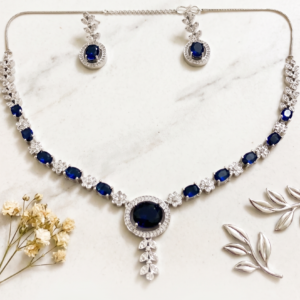 Royal Blue Sapphire Crystal Necklace Set by Manadh Jewels featuring sparkling sapphire-inspired blue stones, premium zircon detailing, matching drop earrings, and an elegant silver-tone design for bridal wear, weddings, receptions, parties, and festive occasions