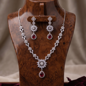 Manadh Jewels Floral Ruby Crystal Necklace Set with matching drop earrings featuring premium crystal floral motifs and ruby-red pear-shaped stones, ideal for bridal wear, weddings, festive celebrations, receptions, and party occasions