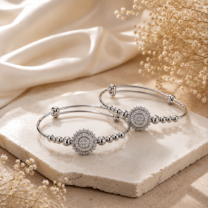 Silver-toned designer bangle set with intricate circular motifs and polished bead detailing