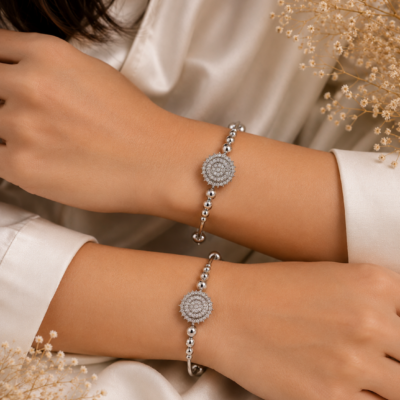 Silver-toned designer bangle set with intricate circular motifs and polished bead detailing