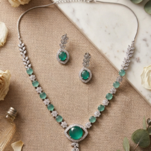 Elegant mint Green Crystal Necklace Set by Manadh Jewels featuring aqua-green gemstones, sparkling crystal leaf motifs, matching drop earrings, and a premium silver-tone finish, perfect for bridal wear, weddings, receptions, festive celebrations, and party occasions
