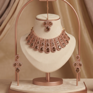 Rose gold plated Indian choker necklace set featuring olive green teardrop stones, clear crystals, matching chandelier drop earrings, and a maang tikka
