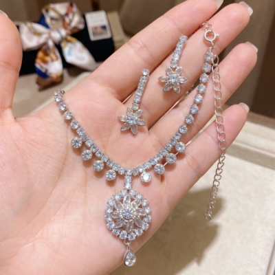 Elegant silver crystal floral necklace set with matching drop earrings