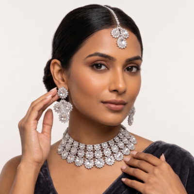 silver stone bridal choker necklace set with matching earrings and maang tikka on black velvet display