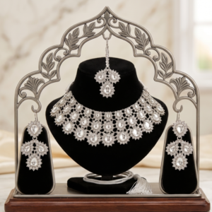 silver stone bridal choker necklace set with matching earrings and maang tikka on black velvet display