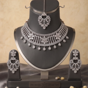 Manadh Jewels silver-tone bridal choker necklace set featuring intricate floral motifs and clear crystal mirror-style stones, complete with matching drop earrings and a coordinating maang tikka