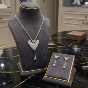 Radiant butterfly necklace and matching drop earrings with sparkling clear crystal-style stones by Manadh Jewels