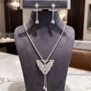 Radiant butterfly necklace and matching drop earrings with sparkling clear crystal-style stones by Manadh Jewels