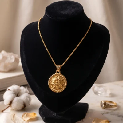 gold tone floral medallion pendant necklace featuring intricate filigree work