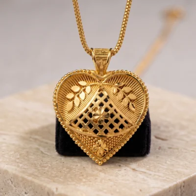 Gold heart pendant necklace with intricate floral openwork design