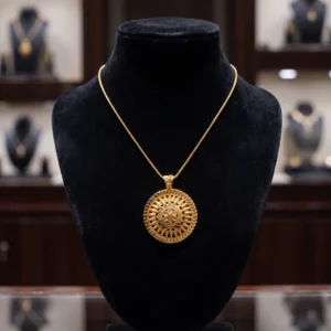 Round gold pendant necklace with ornate medallion design