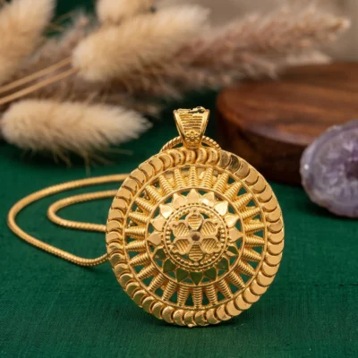 Round gold pendant necklace with ornate medallion design
