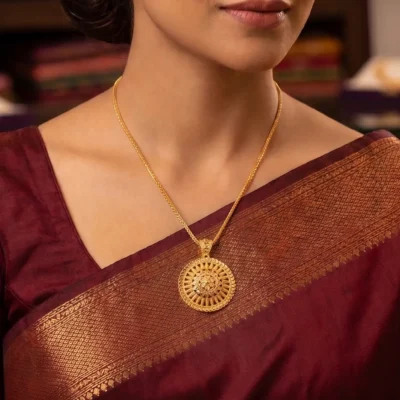 Round gold pendant necklace with ornate medallion design