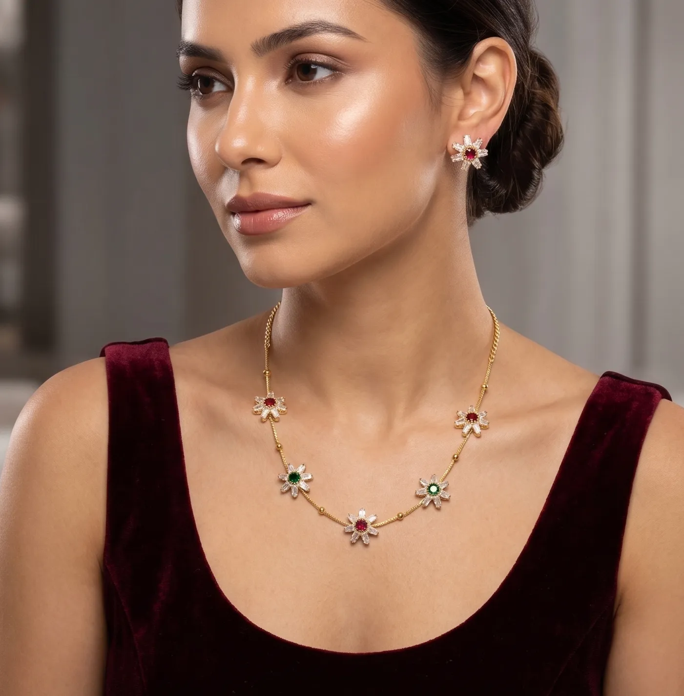 Floral Gold-Plated Necklace Set with Ruby &_ Emerald Color Stones 3 Gold-tone necklace set featuring floral pendants with white, red, and green stones alongside matching stud earrings