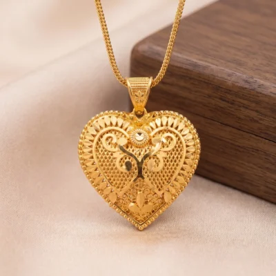 gold heart pendant necklace with intricate filigree design