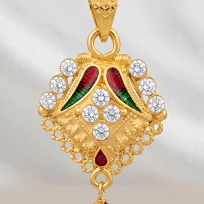 Gold pendant necklace with multicolor details and red bead drop