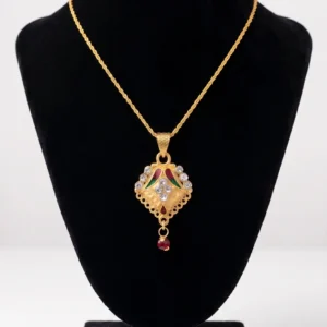 Gold pendant necklace with multicolor details and red bead drop